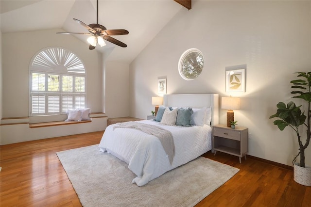 bedroom with wood finished floors, a ceiling fan, and high vaulted ceiling