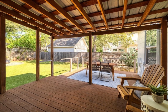 wooden deck with a fenced backyard, a yard, and outdoor dining space