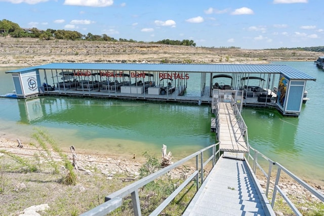view of dock with boat lift and a water view