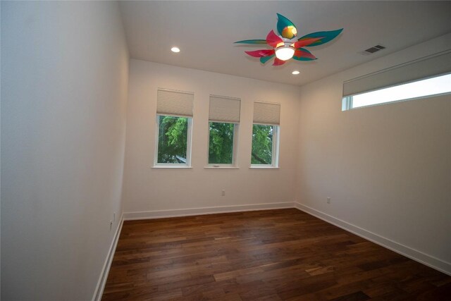 unfurnished room with ceiling fan, dark wood finished floors, baseboards, visible vents, and recessed lighting