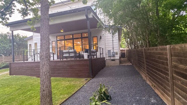 exterior space featuring fence private yard and a lawn