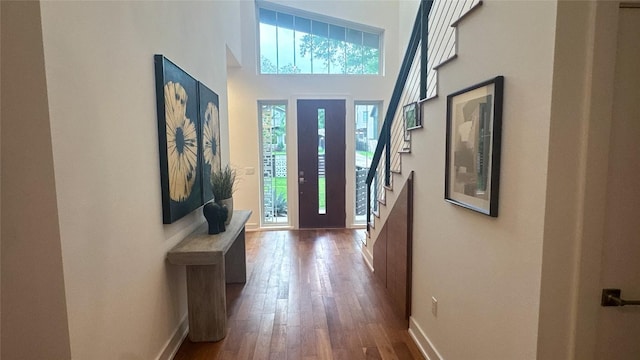 entrance foyer featuring baseboards and hardwood / wood-style flooring