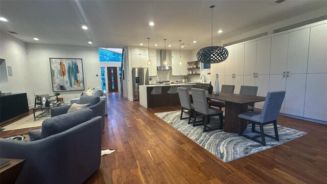 dining area with dark wood finished floors and recessed lighting