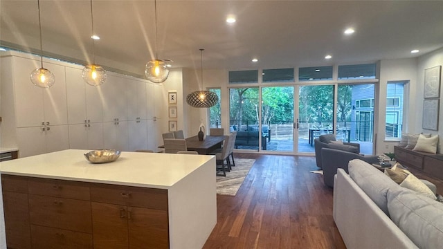 kitchen featuring open floor plan, light countertops, dark wood-style floors, and recessed lighting