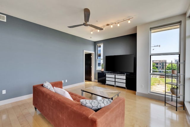 1320 Robert Browning St Unit 409, Austin, TX 78723 - living area featuring ceiling fan, baseboards, and rail lighting