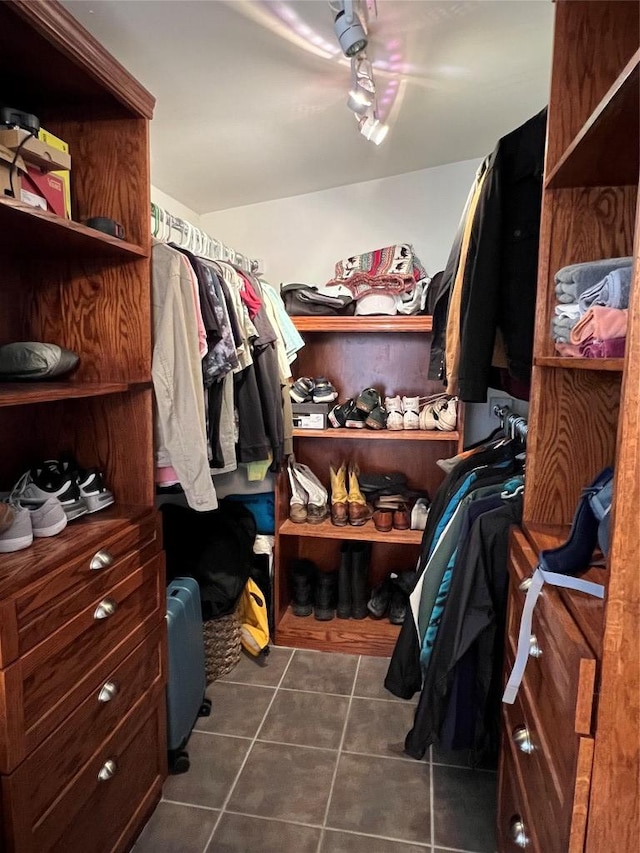 walk in closet featuring dark tile patterned floors
