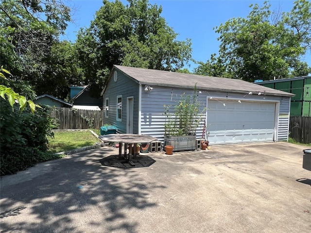 detached garage featuring fence