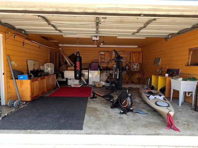 garage featuring wooden walls and a garage door opener