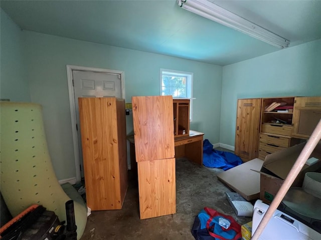 bedroom featuring unfinished concrete flooring