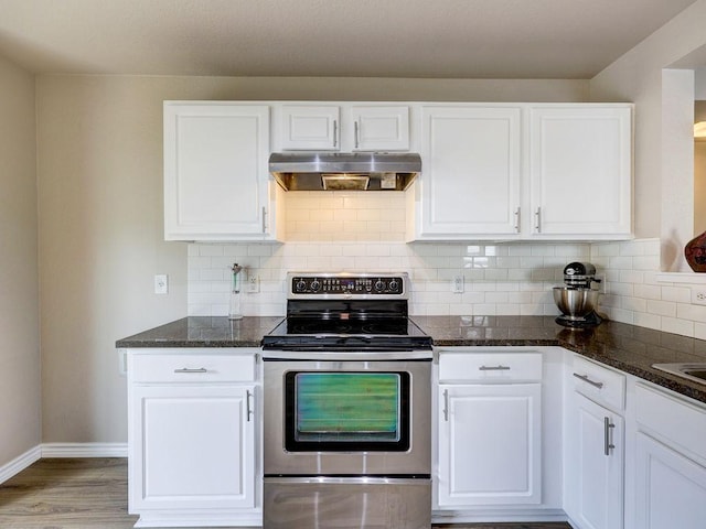 6709 Doyal Dr, Austin, TX 78747 - kitchen with exhaust hood, stainless steel range with electric stovetop, baseboards, white cabinets, and dark stone countertops