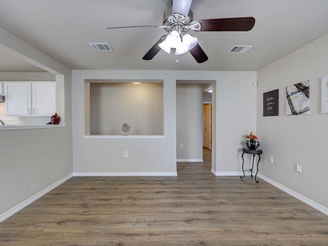 6709 Doyal Dr, Austin, TX 78747 - empty room with ceiling fan, wood finished floors, and baseboards