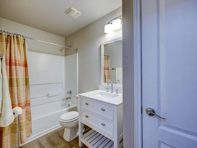 6709 Doyal Dr, Austin, TX 78747 - bathroom featuring toilet, vanity, shower / tub combo with curtain, and wood finished floors