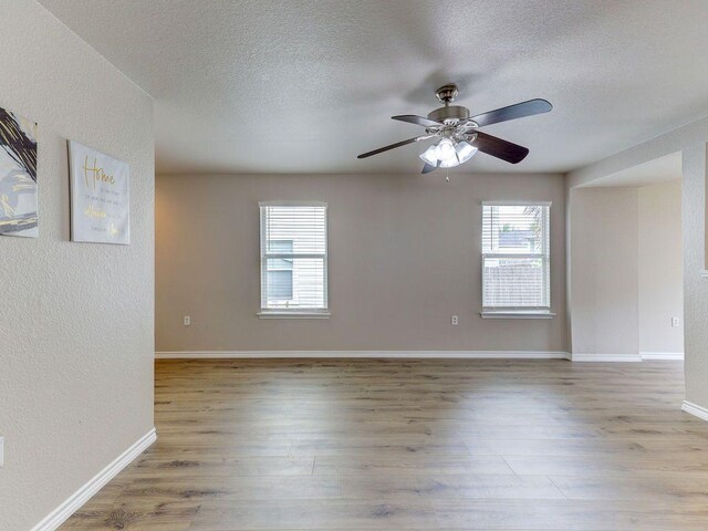 6709 Doyal Dr, Austin, TX 78747 - unfurnished room featuring wood finished floors, a textured ceiling, ceiling fan, a textured wall, and baseboards