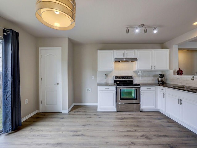 6709 Doyal Dr, Austin, TX 78747 - kitchen with stainless steel electric range, under cabinet range hood, a sink, dark countertops, and decorative backsplash