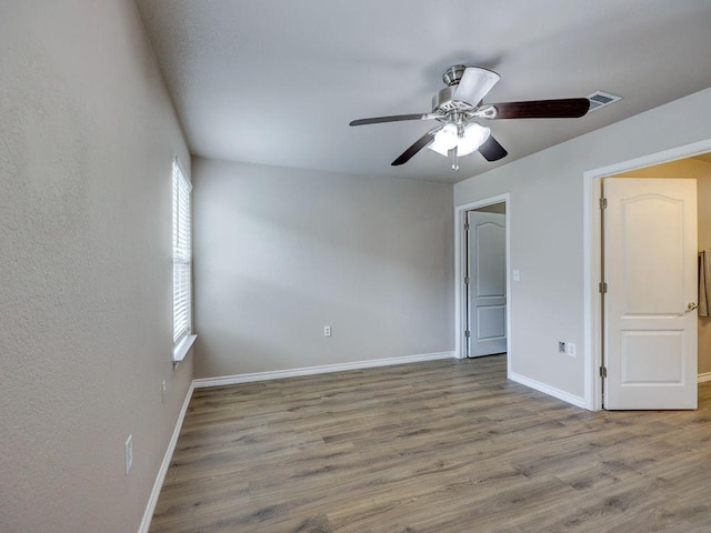 6709 Doyal Dr, Austin, TX 78747 - spare room with ceiling fan, baseboards, and wood finished floors