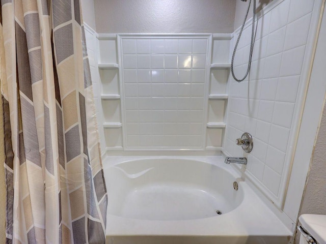 6709 Doyal Dr, Austin, TX 78747 - full bath featuring a textured wall, shower / bathtub combination with curtain, and toilet