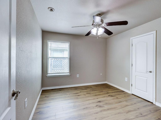6709 Doyal Dr, Austin, TX 78747 - unfurnished room featuring wood finished floors, ceiling fan, baseboards, and a textured wall
