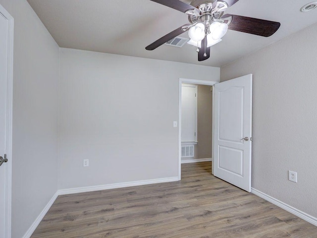 6709 Doyal Dr, Austin, TX 78747 - unfurnished bedroom with wood finished floors, baseboards, and ceiling fan
