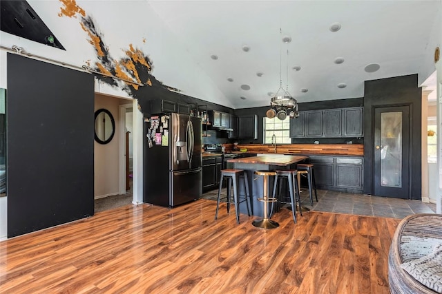 358 Easley Rd, Smithville, TX 78957 - kitchen featuring dark cabinetry, stainless steel refrigerator with ice dispenser, light wood-style flooring, and wooden counters