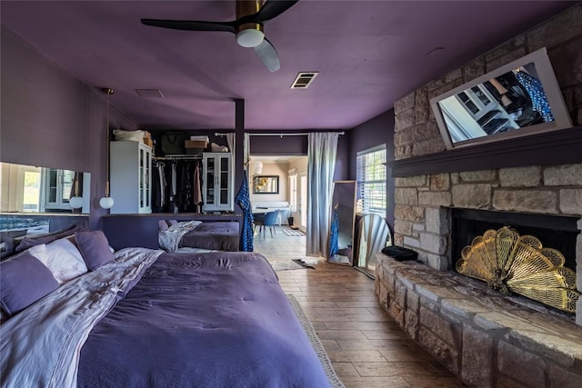358 Easley Rd, Smithville, TX 78957 - bedroom featuring wood-type flooring, a fireplace, and ceiling fan
