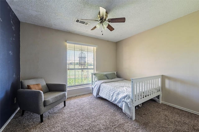 358 Easley Rd, Smithville, TX 78957 - bedroom featuring carpet, a textured ceiling, and a ceiling fan