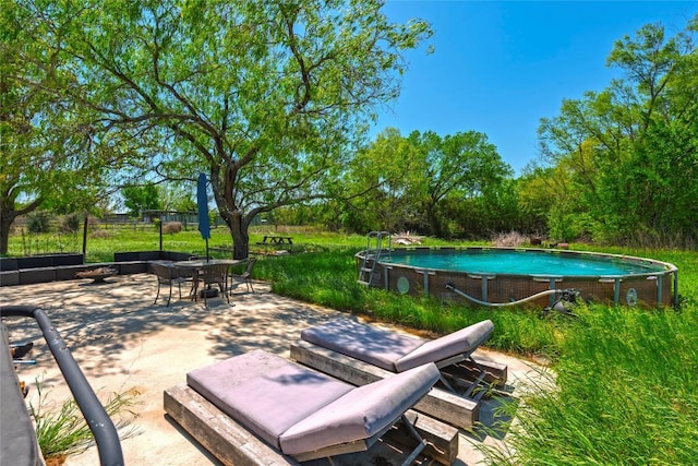 358 Easley Rd, Smithville, TX 78957 - view of patio / terrace with outdoor dining area and an outdoor pool