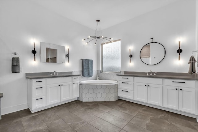 2616 War Wagon Way, Leander, TX 78641 - bathroom featuring a chandelier, two vanities, a garden tub, and tile patterned flooring