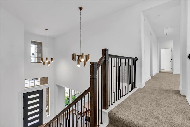 2616 War Wagon Way, Leander, TX 78641 - corridor with plenty of natural light, carpet, a chandelier, and an upstairs landing