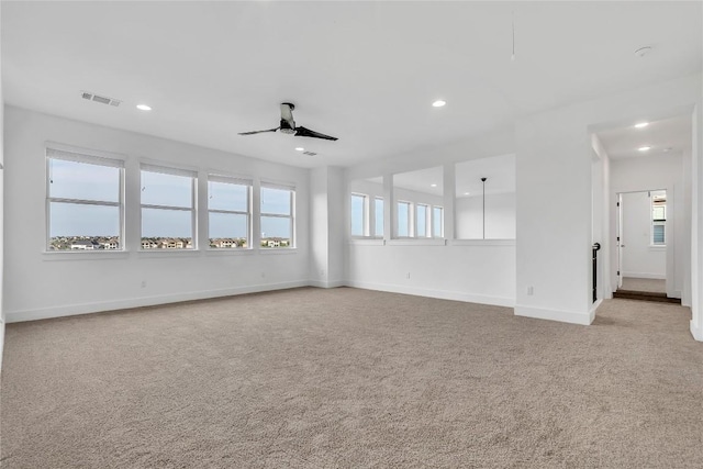 2616 War Wagon Way, Leander, TX 78641 - unfurnished room featuring light colored carpet, recessed lighting, plenty of natural light, and a ceiling fan