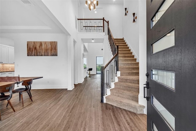 2616 War Wagon Way, Leander, TX 78641 - foyer with a towering ceiling, stairs, wood finished floors, baseboards, and a chandelier