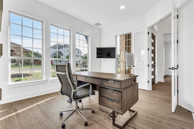 2616 War Wagon Way, Leander, TX 78641 - home office with plenty of natural light, wood finished floors, baseboards, and recessed lighting