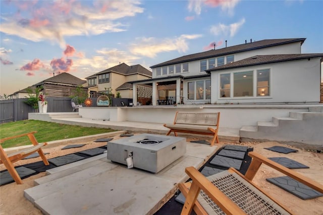 2616 War Wagon Way, Leander, TX 78641 - rear view of house with a fire pit, a patio area, and stucco siding