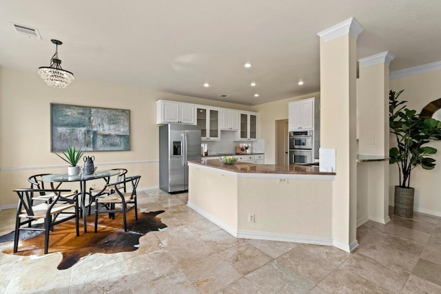 10012 Scull Creek Dr, Austin, TX 78730 - kitchen with stainless steel appliances, white cabinets, recessed lighting, glass insert cabinets, and a peninsula