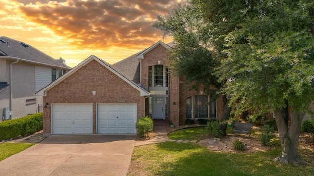 10012 Scull Creek Dr, Austin, TX 78730 - traditional-style house with brick siding, an attached garage, concrete driveway, and a front yard
