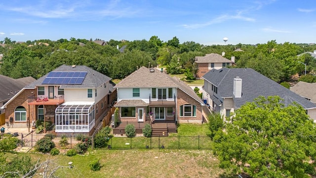 10012 Scull Creek Dr, Austin, TX 78730 - back of house featuring a sunroom, a fenced backyard, and brick siding