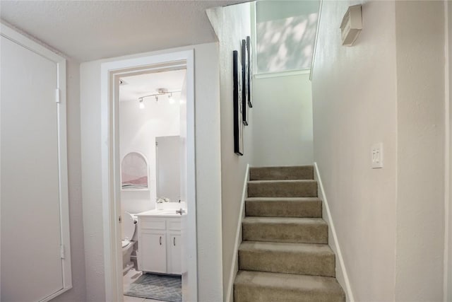 1908 Trevino Dr, Austin, TX 78746 - staircase featuring a textured ceiling