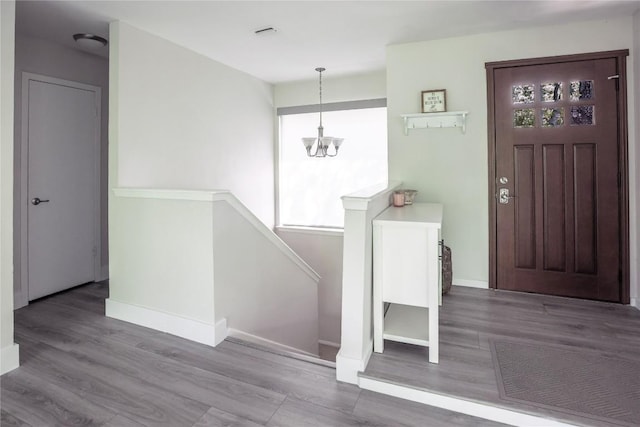 1908 Trevino Dr, Austin, TX 78746 - entrance foyer featuring a chandelier, wood finished floors, and baseboards