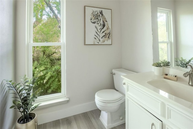 1908 Trevino Dr, Austin, TX 78746 - half bath with toilet, vanity, wood finished floors, and baseboards