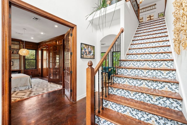 45 Saddle Rock Rdg, Wimberley, TX 78676 - stairs featuring arched walkways, french doors, baseboards, visible vents, and recessed lighting