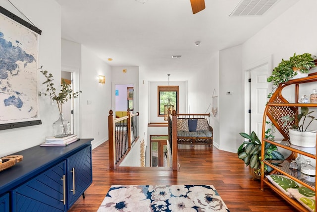 45 Saddle Rock Rdg, Wimberley, TX 78676 - hallway featuring wood finished floors, visible vents, baseboards, and an upstairs landing
