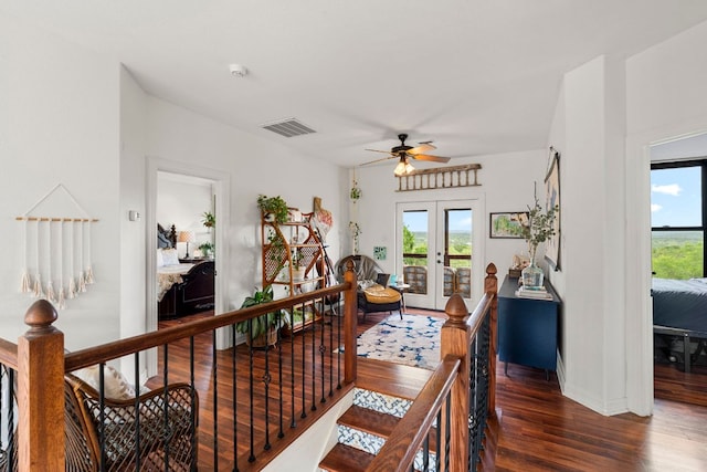 45 Saddle Rock Rdg, Wimberley, TX 78676 - hall featuring french doors, dark wood finished floors, plenty of natural light, visible vents, and an upstairs landing