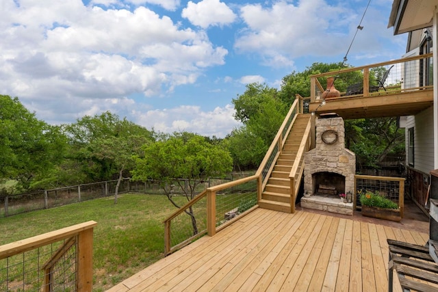 45 Saddle Rock Rdg, Wimberley, TX 78676 - deck with a fenced backyard, an outdoor stone fireplace, stairs, and a lawn