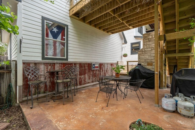 45 Saddle Rock Rdg, Wimberley, TX 78676 - view of patio / terrace with outdoor dining area, fence, and grilling area