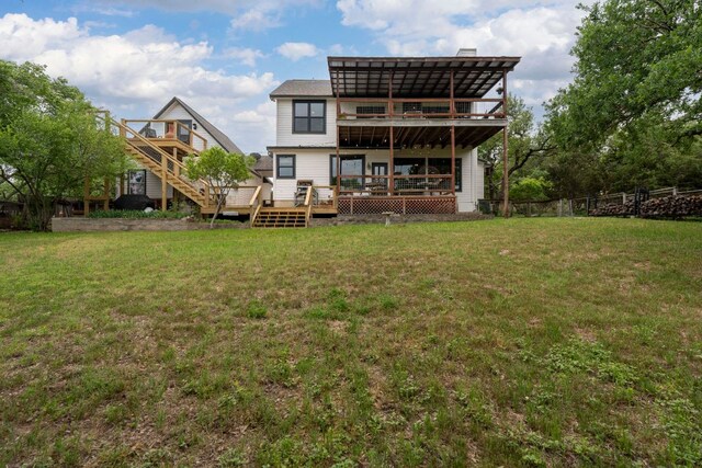 45 Saddle Rock Rdg, Wimberley, TX 78676 - rear view of house featuring a lawn, fence, a deck, and a balcony