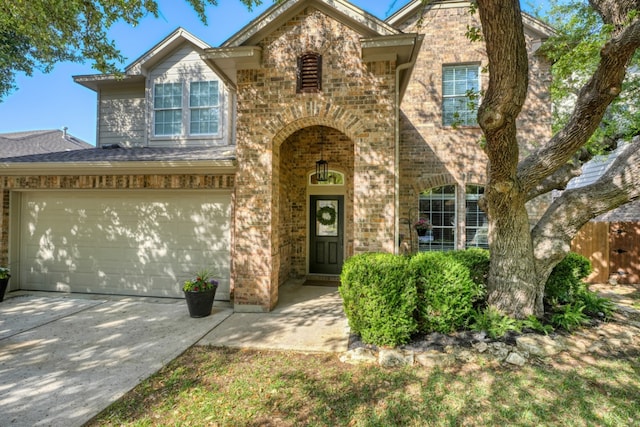 3818 Sky Ln, Round Rock, TX 78681 - traditional-style home with brick siding, an attached garage, concrete driveway, and fence