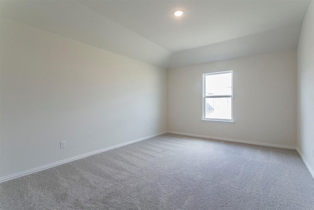 carpeted spare room featuring baseboards and recessed lighting