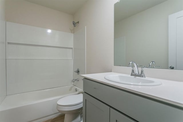 full bathroom featuring tub / shower combination, toilet, and vanity