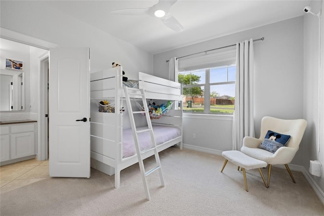 bedroom featuring light carpet, baseboards, and ceiling fan