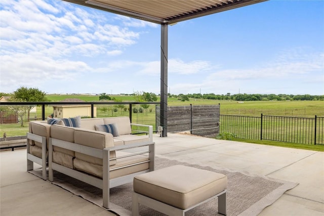 view of patio featuring outdoor lounge area, fence, and a rural view