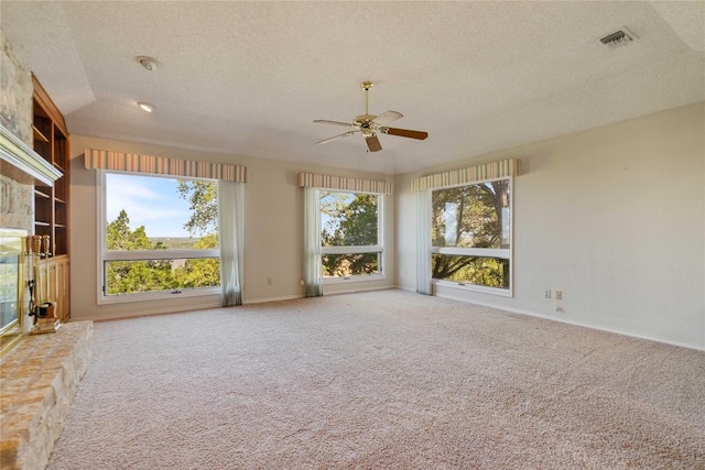 21407 High Dr, Lago Vista, TX 78645 - unfurnished living room with a textured ceiling, ceiling fan, and carpet flooring